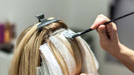 Hairdresser Doing A Highlights Touch Up