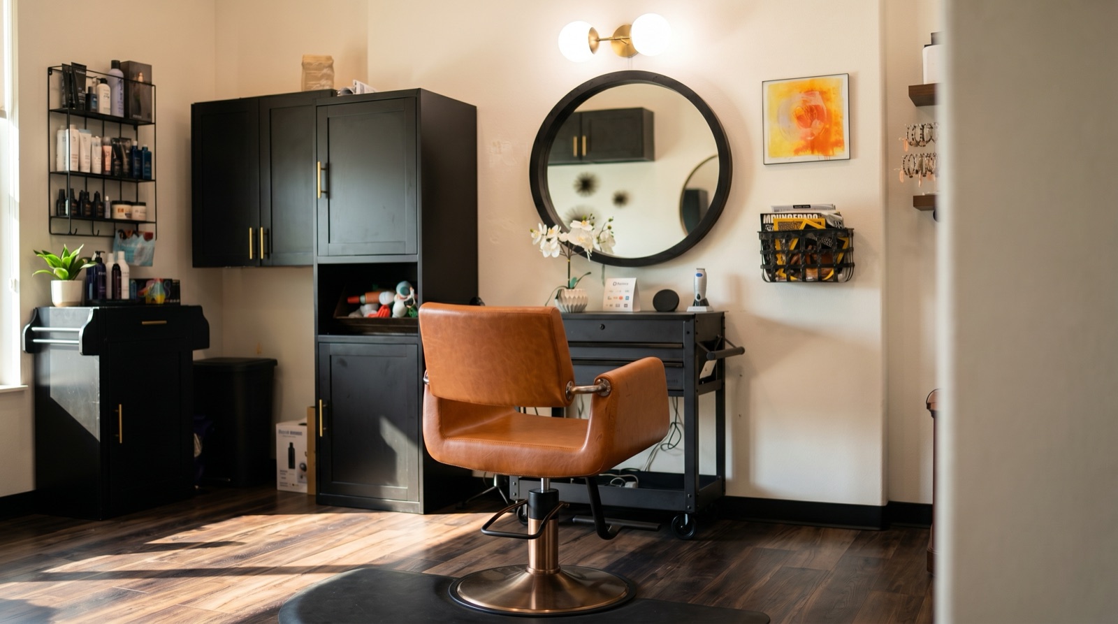 Scott Farmer Hair Salon interior Venice FL with terracotta leather styling chair, round black mirror and brass sconce